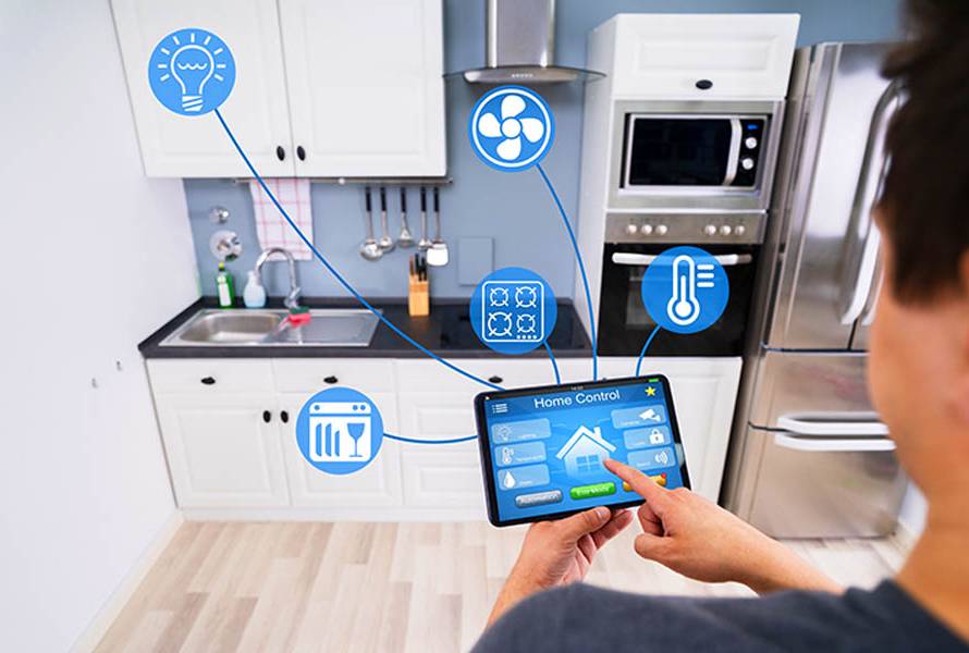 The Future of Home Automation - How To Make Your Home Smarter Today; Close-up Of A Person's Hand Using Smart Home Application On Smartphone In Kitchen
